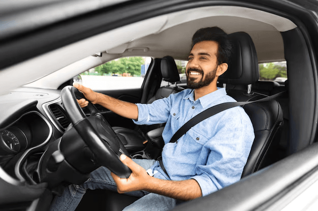 A smiling ViiRide driver behind the wheel